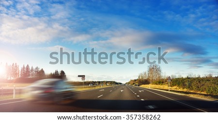Blurred car on asphalt road in early morning