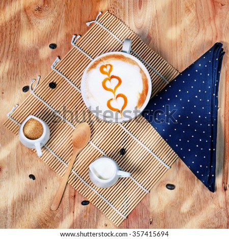Capucino art coffee on wooden texture table