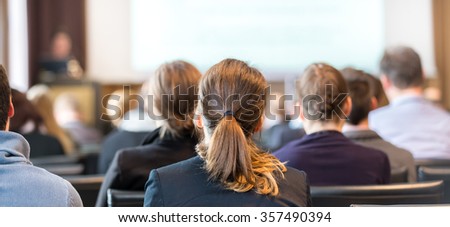 Speaker Giving a Talk at Business Meeting. Audience in the conference hall. Business and Entrepreneurship. Panoramic composition suitable for banners.