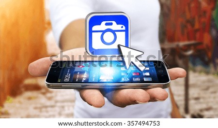 Young man with modern mobile phone in his hand using modern camera application