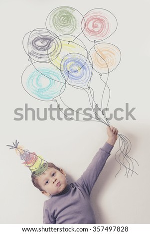Child with balloons. The painting on the wall. Postcard happy birthday. Imagination, celebration and freedom concept.