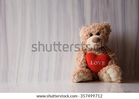 Romantic teddy bear on white