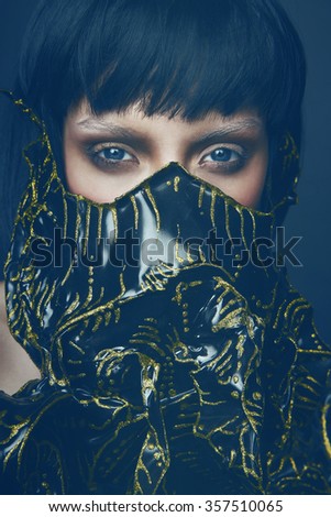 Portrait of young female model in creative mask 