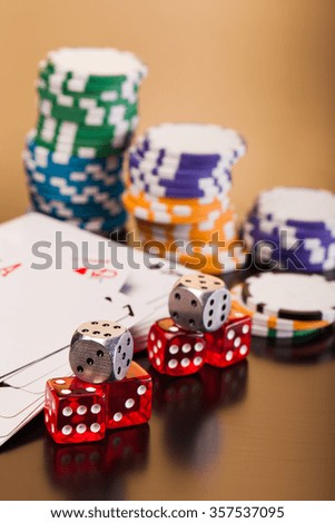 set of playing card with dices on reflective table