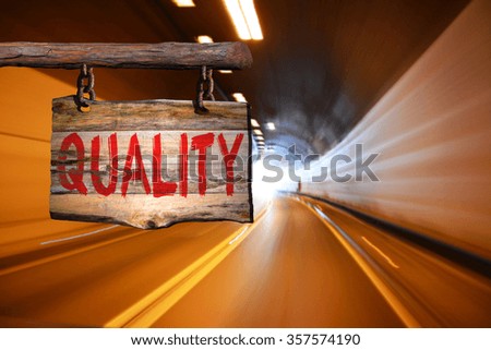 Quality motivational phrase sign on old wood with blurred background