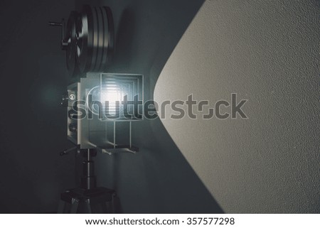 Old style movie camera at grey wall background