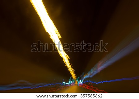 Photo closeup of night time modern new highway crooked alignment of road broadway through passage colorful illumination and light trails on motion blurred background, horizontal picture