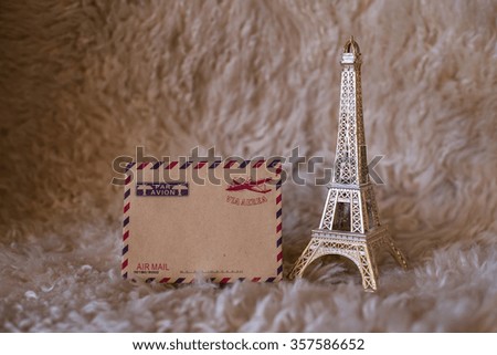 Empty vintage card with statuette of Eiffel Tower. High sharpness.