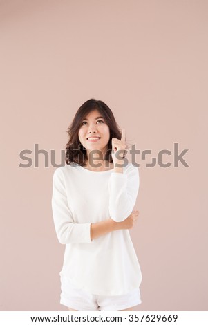 Beautiful woman with idea light bulb above hand