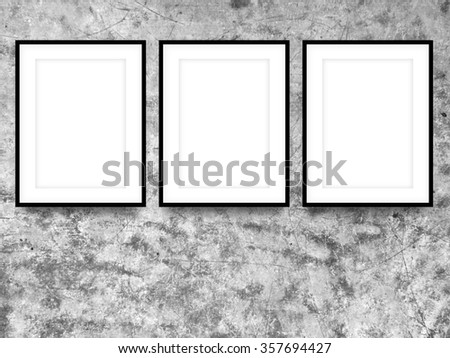 Close-up of three black picture frames on scratched metal background