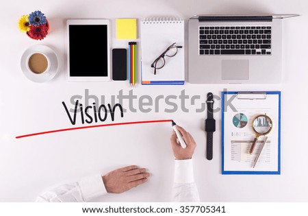 Business Concept: Businessman writing the words VISION