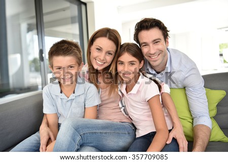 Portrait of happy family sitting in sofa