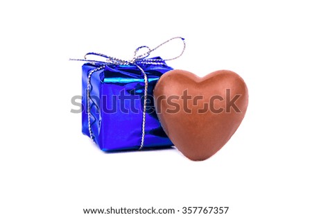 Chocolate candy in the shape of heart and a gift for Valentine's Day