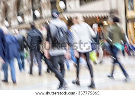 City spree, shopper walking against shop window