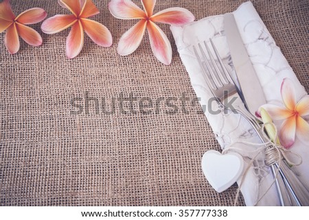 Valentines Plumeria Frangipani flower Table setting copy space background, selective focus, toning