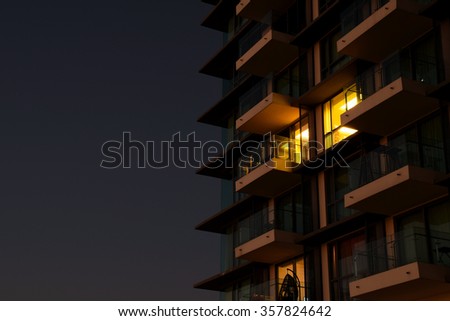 Yellow Light from apartment Room at night background Royalty-Free Stock Photo #357824642