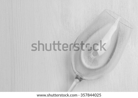 wine glass with water isolated on white wood textured background