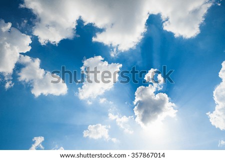 Blue sky with clouds and sun. 