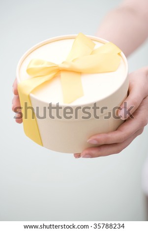 A lovely gift box with woman's hands