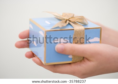 A lovely gift box with woman's hands