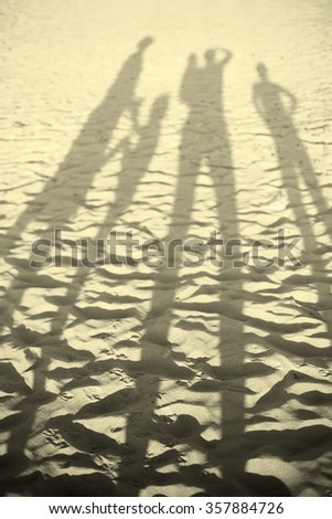 happy large family on beach sunset shadows, shallow DOF, black and white, toned