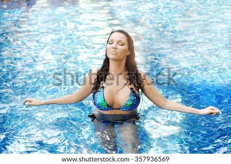 Woman relaxing in swimming-pool