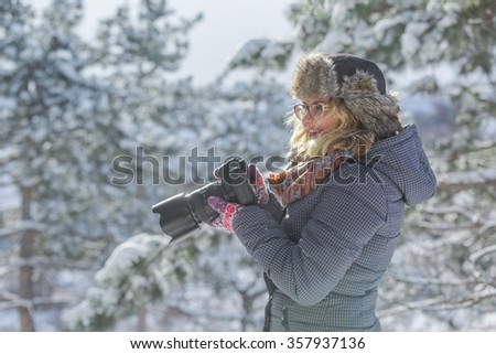 photographer in the  winter forest