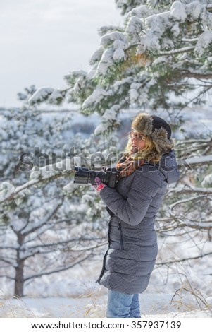 photographer in the  winter forest