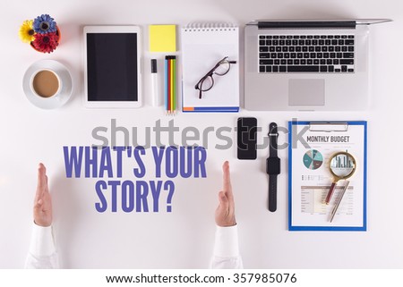 Businessman working on desk - hands showing WHAT'S YOUR STORY? concept
