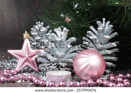 Various ornaments for the Christmas and New Year, shiny toys, cones, stars near the fir branches