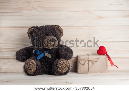 teddy bear and heart on a background of wooden planks
