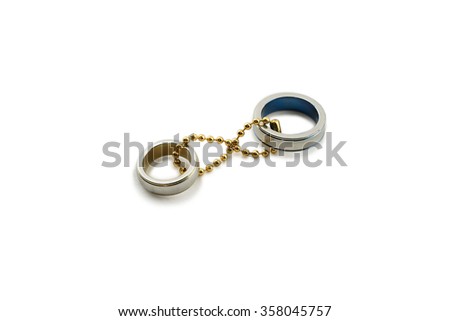 Couple wedding ring tie together with gold key chain in number eight representing eternity love or infinity love isolate with white background, concept of love symbol, valentine's day, wedding band.