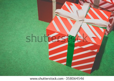 Colorful paper gift boxes wrapped in ribbon bow on floor background. Merry Christmas present package. Anniversary Birthday or Happy new year concept. Copy space