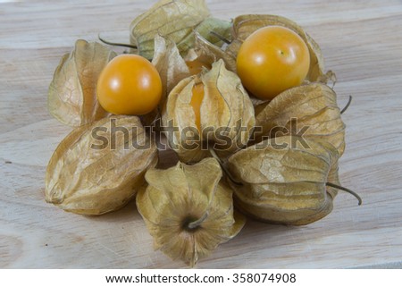 Cape gooseberry (Physalis) on wooden table, healthy fruit and vegetable