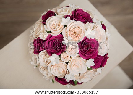 a bridal bouquet made of polymer clay with gold wedding rings in the studio