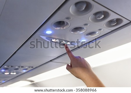 Finger show on Fasten Seat belt Sign Inside an airplane
