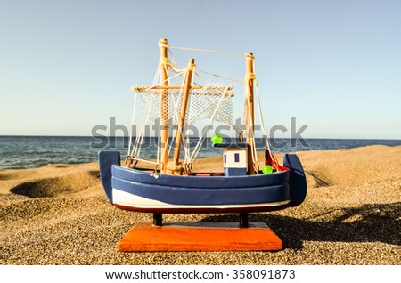 Toy Boat on the Sand Beach