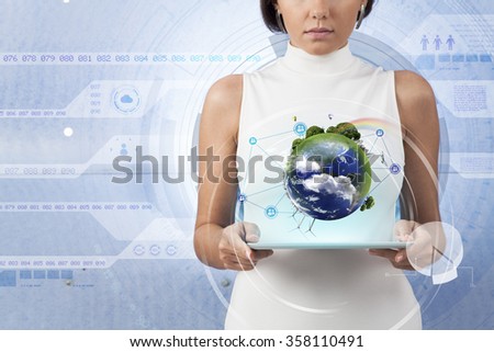 Image of businesswoman with tablet pc against high-tech background. Elements of this image furnished by NASA 