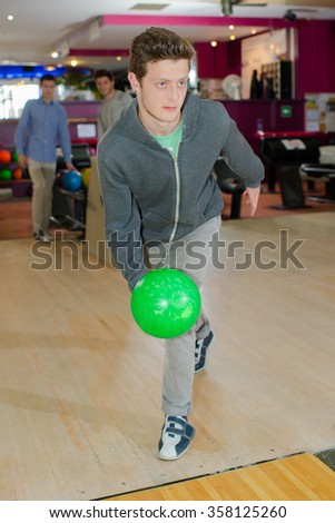 young man playing bowling