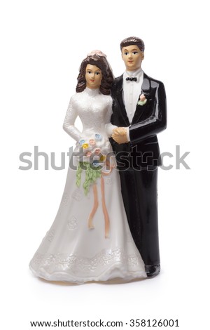 Bride and groom, old cake topper on white background Royalty-Free Stock Photo #358126001