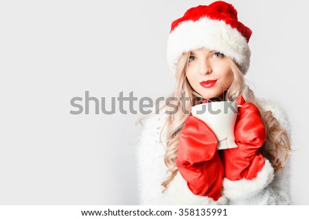 Portrait of joyful pretty woman in red santa claus hat laughing isolated on white background. Beautiful girl looking happy and excited. Happy Christmas and New Year holidays full of fun.