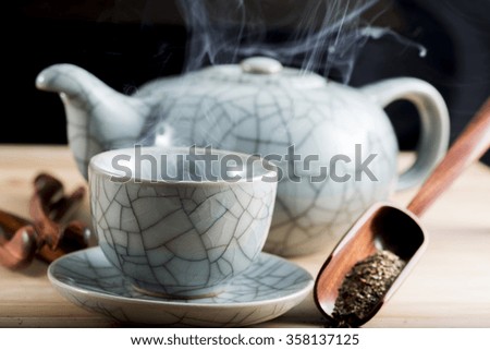 Traditional cup of steaming tea with accessories for infusion