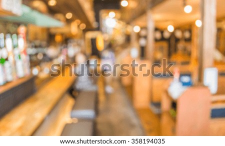 blur image of japan restaurant and lady customer waiting for her meal for background usage.