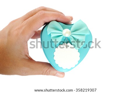 Blue heart shape gift box in hand isolated on white background, valentine's day concept