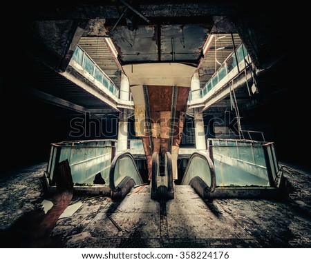 Dramatic view of damaged escalators in abandoned building. Apocalyptic and evil concept