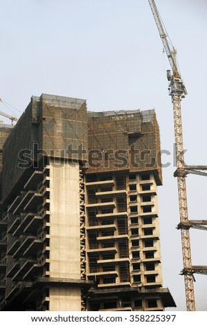 building construction site with frame and crane