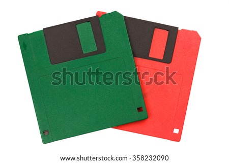 Green and red vintage floppy disks isolated on white background