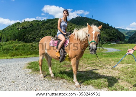 Young Woman riding a horse