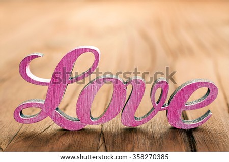 The word love on a wooden background