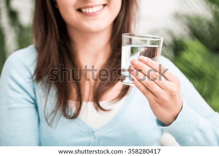 Picture of young female refreshing herself with water
